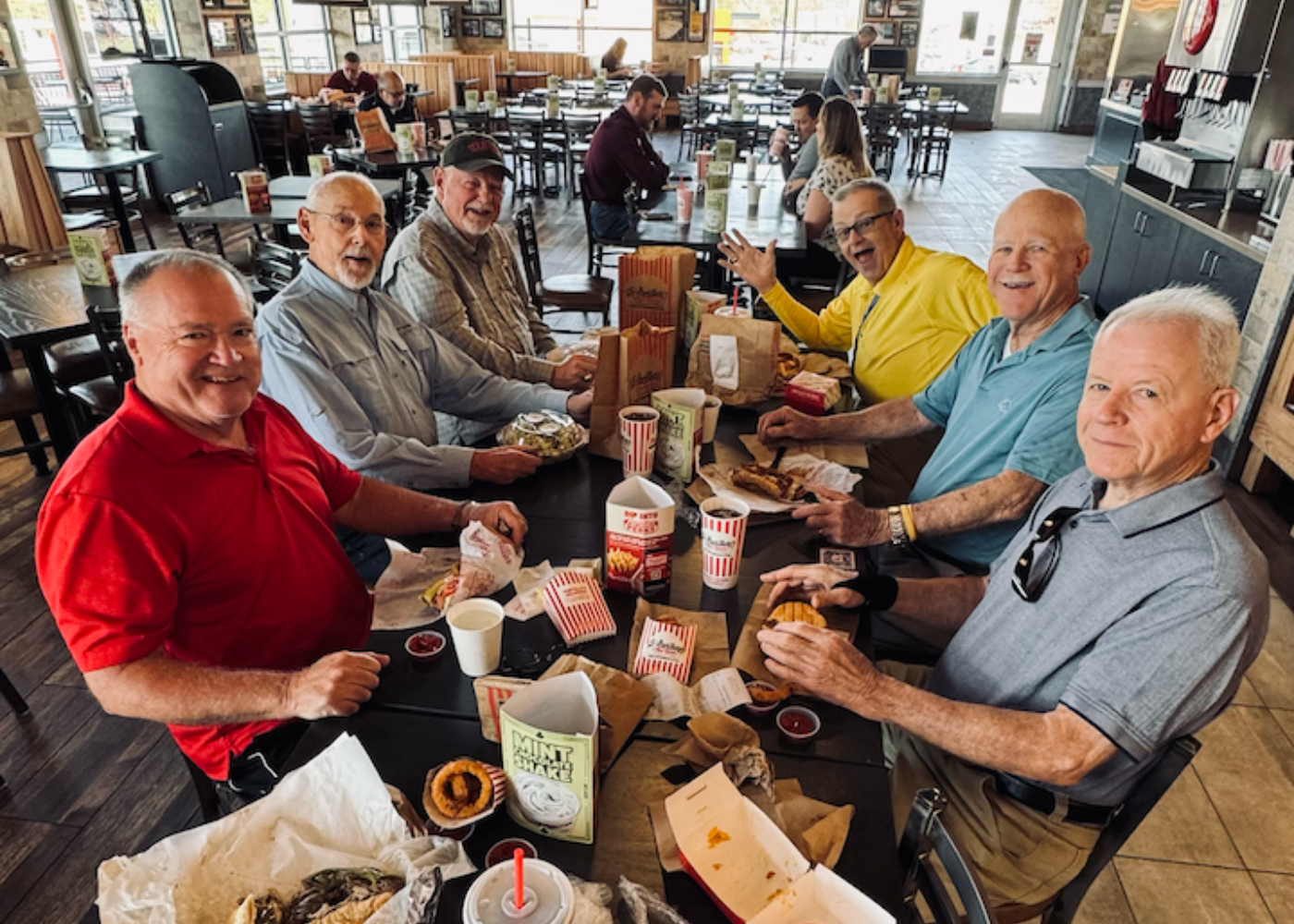 Adult ministry people sitting on chair in front of table while holding pens during daytime